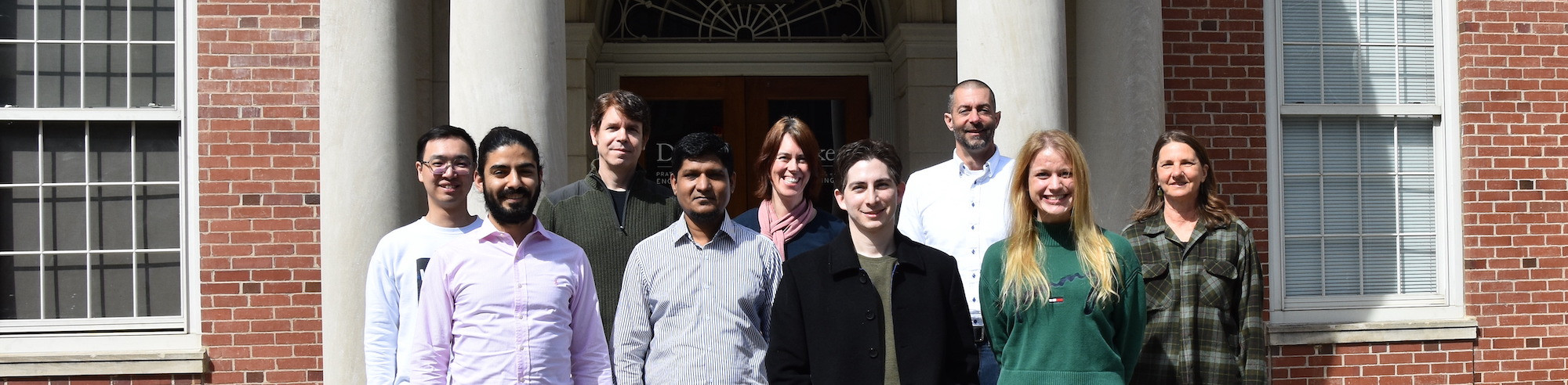 members of McIntyre Lab standing in front of Hudson Hall
